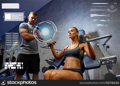 sport, fitness, bodybuilding, exercising and people concept - young woman and personal trainer with smartphone flexing muscles on gym machine over virtual charts. man and woman flexing muscles on gym machine