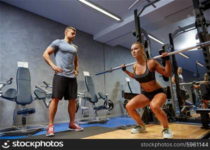 sport, fitness, bodybuilding, lifestyle and people concept - man and woman with bar flexing muscles in gym