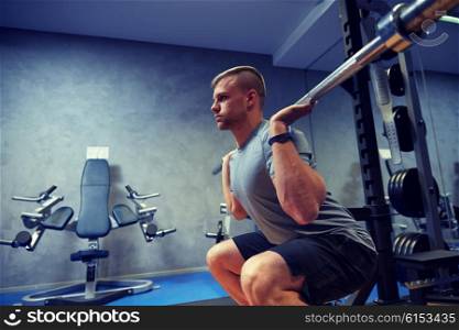 sport, fitness, bodybuilding, lifestyle and people concept - young man with barbell flexing muscles in gym