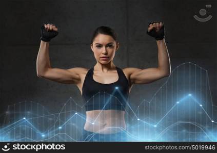 sport, fitness, bodybuilding, weightlifting and people concept - young woman flexing muscles in gym. young woman flexing muscles in gym