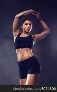 sport, fitness, bodybuilding, weightlifting and people concept - young woman posing and showing muscles in gym. young woman posing and showing muscles in gym. young woman posing and showing muscles in gym