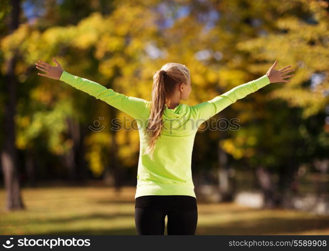 sport, fitness, exercise and lifestyle concept - woman doing sports outdoors