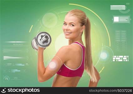 sport, fitness, exercising, technology and people concept - happy young sporty woman with dumbbell flexing biceps over green background. happy sporty woman with dumbbell flexing biceps