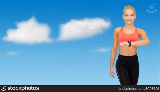 sport, fitness, exercising, technology and people - smiling woman with heart rate bracelet on hand over blue sky and clouds background