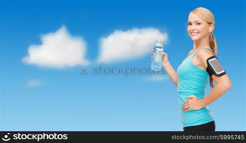 sport, fitness, exercising, technology and people - sporty woman listening to music from smartphone with water bottle over blue sky and clouds background