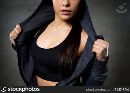 sport, fitness, fashion and people concept - close up of woman posing and showing sportswear