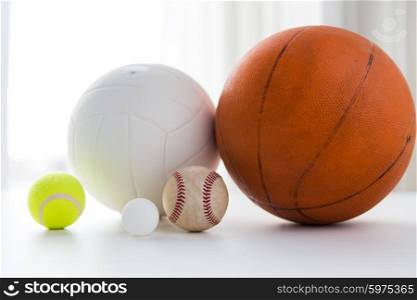 sport, fitness, game and objects concept - close up of different sports balls set