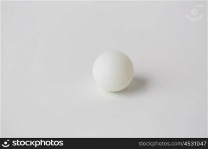 sport, fitness, game, sports equipment and objects concept - close up of ping-pong or table tennis ball over white background