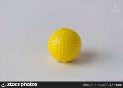 sport, fitness, game, sports equipment and objects concept - close up of yellow golf ball