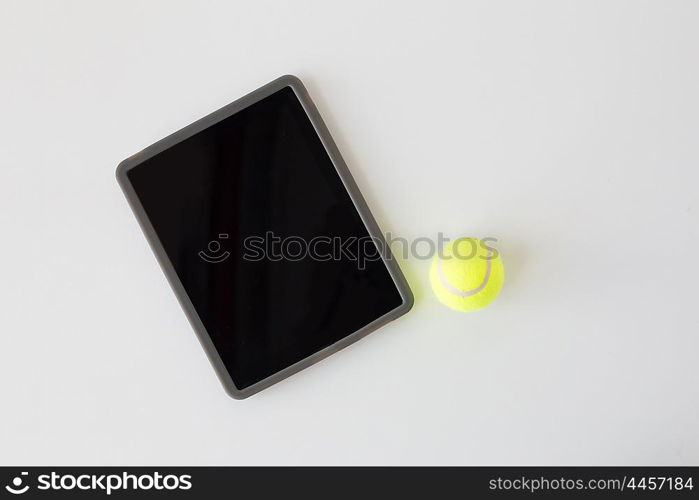 sport, fitness, game, sports equipment and technology concept - close up of tennis ball and tablet pc computer with black blank screen over white background from top