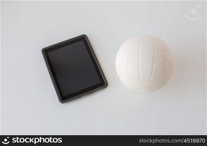 sport, fitness, game, sports equipment and technology concept - close up of volleyball ball and tablet pc computer with black blank screen on white background