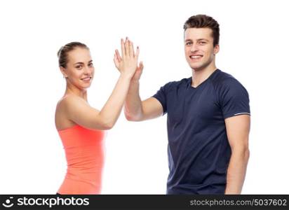 sport, fitness, gesture, lifestyle and people concept - smiling man and woman making high give. happy sportive man and woman making high five