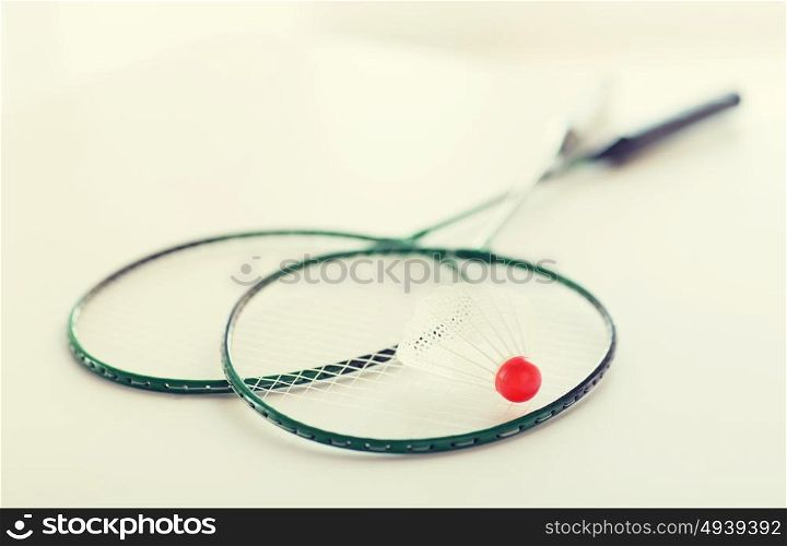 sport, fitness, healthy lifestyle and objects concept - close up of badminton rackets with shuttlecock. close up of badminton rackets with shuttlecock