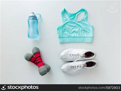 sport, fitness, healthy lifestyle and objects concept - close up of female sports clothing, dumbbells and bottle set
