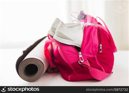 sport, fitness, healthy lifestyle and objects concept - close up of female sports stuff in bag
