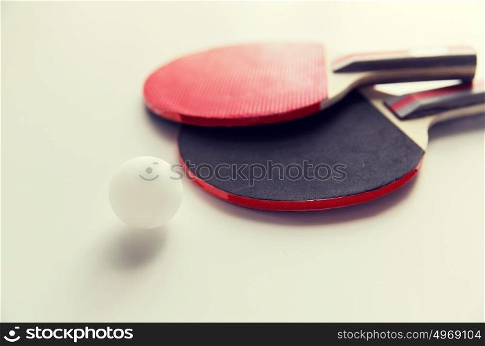 sport, fitness, healthy lifestyle and objects concept - close up of ping-pong or table tennis rackets with ball. close up of table tennis rackets with ball