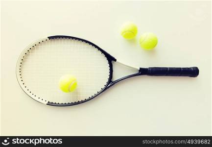 sport, fitness, healthy lifestyle and objects concept - close up of tennis racket with balls. close up of tennis racket with balls