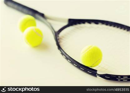 sport, fitness, healthy lifestyle and objects concept - close up of tennis racket with balls. close up of tennis racket with balls