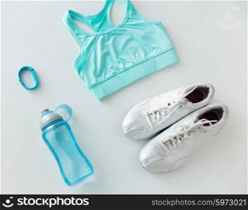 sport, fitness, healthy lifestyle, cardio training and objects concept - close up of female sports clothing, heart-rate watch and bottle set