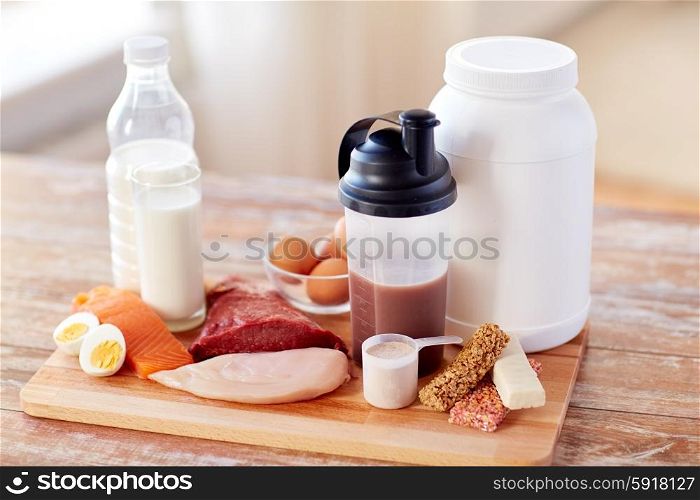 sport, fitness, healthy lifestyle, diet and people concept - close up of natural protein food and additive on wooden table