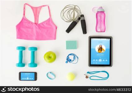 sport, fitness, healthy lifestyle, technology and objects concept - close up of tablet pc computer with smartphone and sports stuff over white background