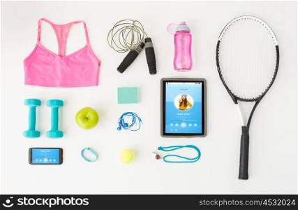 sport, fitness, healthy lifestyle, technology and objects concept - tablet pc computer with smartphone and sports stuff over white background