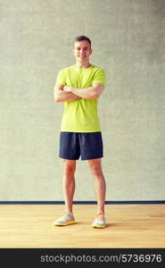 sport, fitness, lifestyle and people concept - smiling man in gym