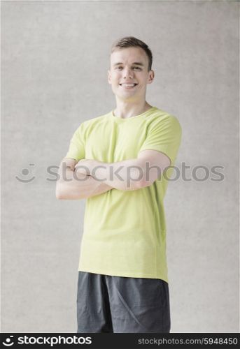 sport, fitness, lifestyle and people concept - smiling man in gym