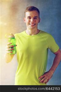 sport, fitness, lifestyle and people concept - smiling man with bottle of water in gym. smiling man with bottle of water in gym