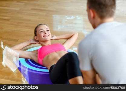 sport, fitness, lifestyle and people concept - smiling woman with male personal trainer exercising in gym