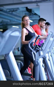 sport, fitness, lifestyle, technology and people concept - smiling woman exercising on treadmill in gym