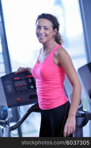 sport, fitness, lifestyle, technology and people concept - smiling woman exercising on treadmill in gym