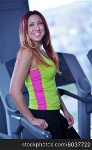 sport, fitness, lifestyle, technology and people concept - smiling woman exercising on treadmill in gym