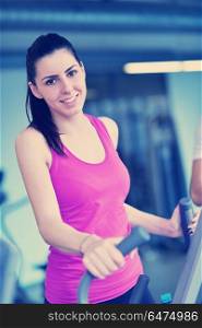 sport, fitness, lifestyle, technology and people concept - smiling woman exercising on treadmill in gym. woman exercising on treadmill in gym