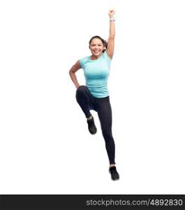 sport, fitness, motion and people concept - happy smiling young woman jumping in superhero pose over white background