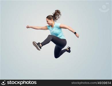 sport, fitness, motion and people concept - happy smiling young woman jumping in air over blue background. happy smiling sporty young woman jumping in air