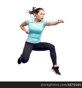 sport, fitness, motion and people concept - happy young woman jumping in air in fighting pose over white background