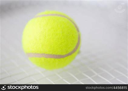 sport, fitness, sports equipment and objects concept - close up of tennis racket with ball