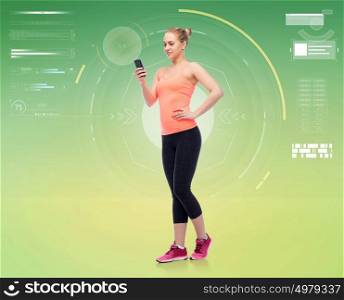 sport, fitness, technology and people concept - happy smiling sportive young woman with smartphone over green background. happy smiling sportive young woman with smartphone