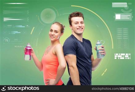 sport, fitness, technology and people concept - happy sportive man and woman with water bottles over green background. sportive man and woman with water bottles