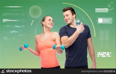 sport, fitness, technology and people concept - happy sportive man and woman with dumbbells and water bottle. sportive man and woman with dumbbells and water