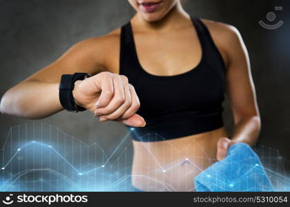 sport, fitness, technology and people concept - young woman with heart-rate watch in gym. woman with heart-rate watch in gym
