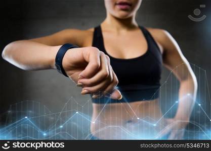 sport, fitness, technology and people concept - young woman with heart-rate watch in gym. woman with heart-rate watch in gym