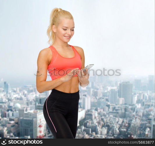 sport, fitness, technology, internet and healthcare concept - smiling sporty woman with smartphone