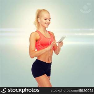 sport, fitness, technology, internet and healthcare concept - smiling sporty woman with smartphone and earphones