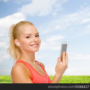 sport, fitness, technology, internet and healthcare - smiling sporty woman with smartphone and earphones