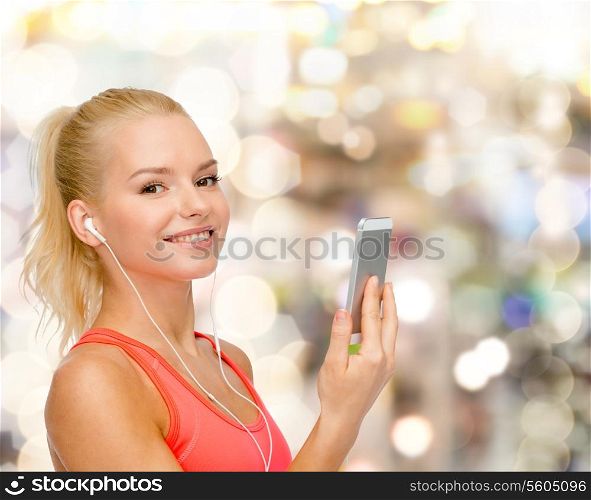 sport, fitness, technology, internet and healthcare - smiling sporty woman with smartphone and earphones