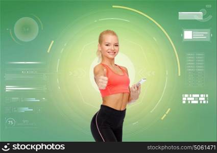 sport, fitness, technology, internet and healthcare - smiling sporty woman with smartphone showing thumbs up. smiling sporty woman with smartphone