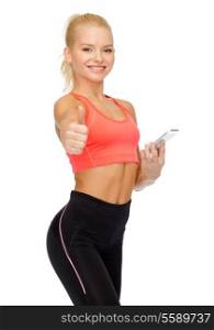 sport, fitness, technology, internet and healthcare - smiling sporty woman with smartphone showing thumbs up
