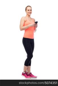 sport, fitness, technology, lifestyle and people concept - happy smiling sportive young woman with smartphone. happy smiling sportive young woman with smartphone